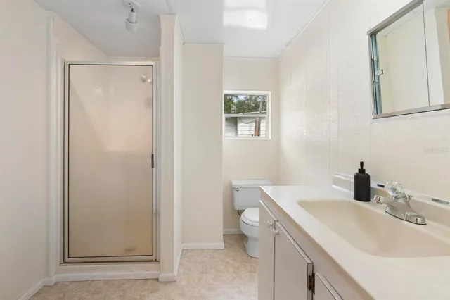 a bathroom with a toilet and a shower