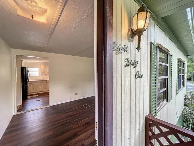 a kitchen with granite countertop a refrigerator and a stove top oven