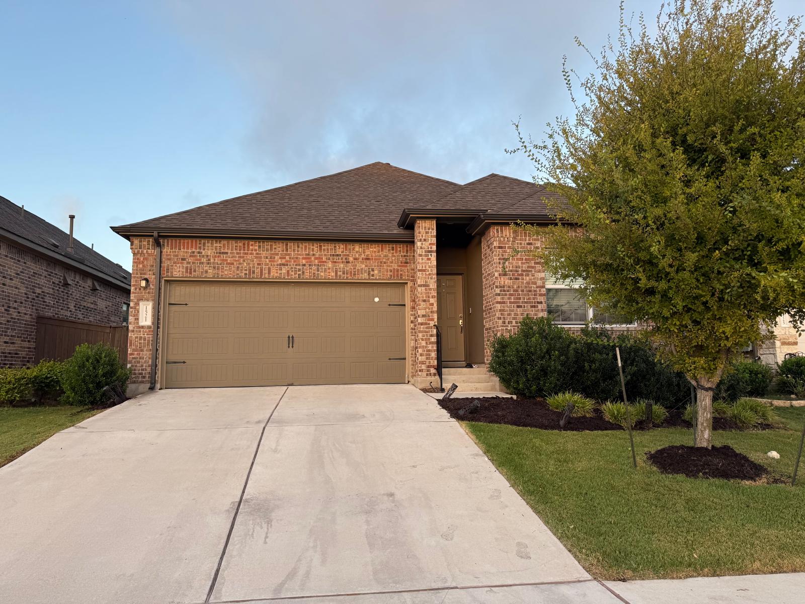 1521 Brueggerhoff Road Leander, TX 78641 - Photo 1 of 15 Classic brick exterior meets manicured landscaping and a spacious concrete driveway.