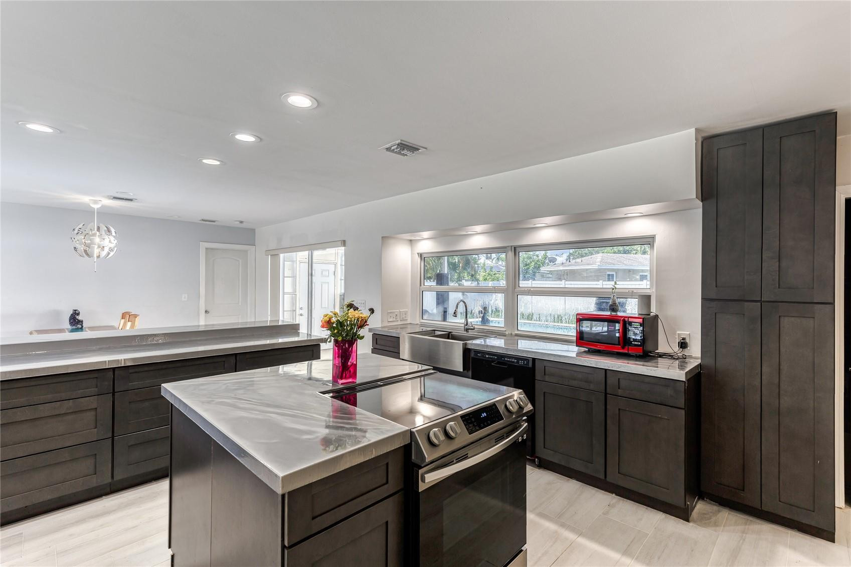601 Southwest 8th Terrace Boca Raton, FL 33486 - Photo 11 of 47 a kitchen with a sink dishwasher stove and refrigerator