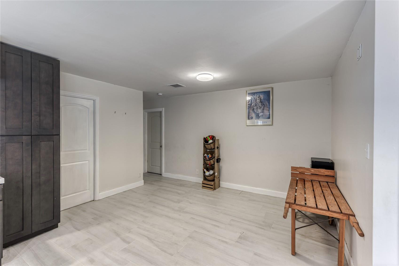 601 Southwest 8th Terrace Boca Raton, FL 33486 - Photo 19 of 47 an empty room with stairs and wooden floor