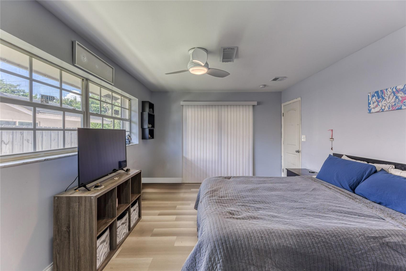 601 Southwest 8th Terrace Boca Raton, FL 33486 - Photo 25 of 47 a bedroom with a bed and a flat tv screen on the dresser