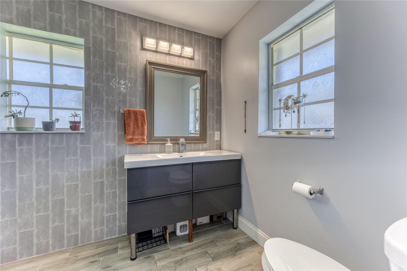 601 Southwest 8th Terrace Boca Raton, FL 33486 - Photo 26 of 47 a bathroom with a sink mirror vanity and toilet