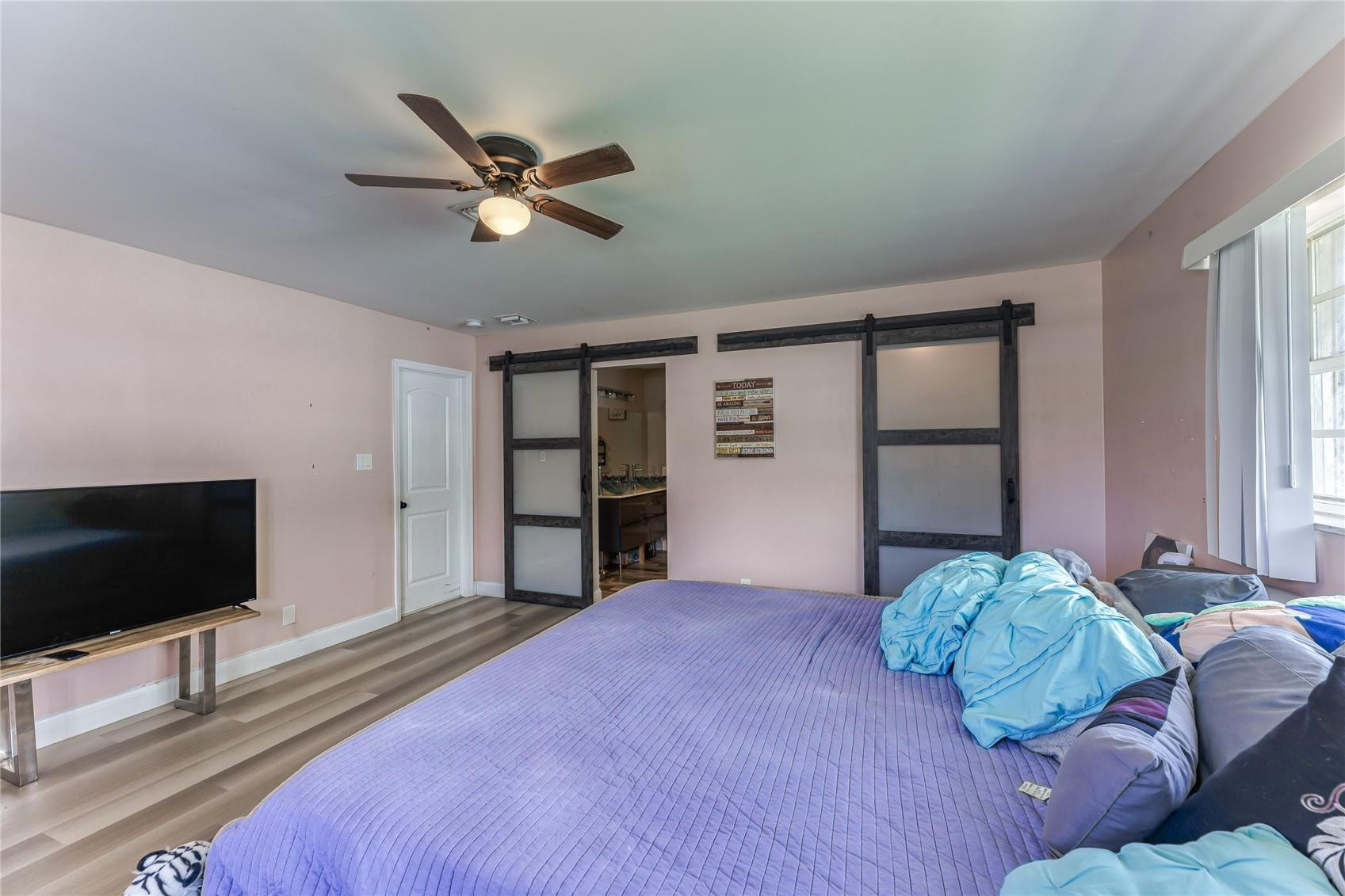601 Southwest 8th Terrace Boca Raton, FL 33486 - Photo 32 of 47 a bedroom with a bed and a flat screen tv