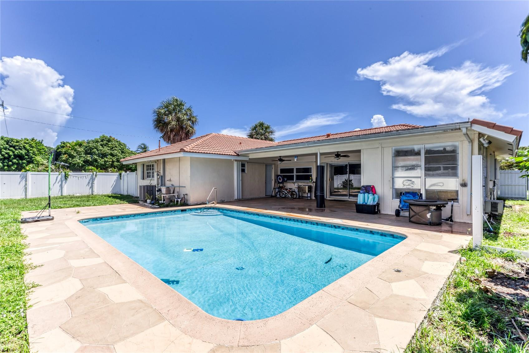 601 Southwest 8th Terrace Boca Raton, FL 33486 - Photo 38 of 47 a view of a house with swimming pool and sitting area