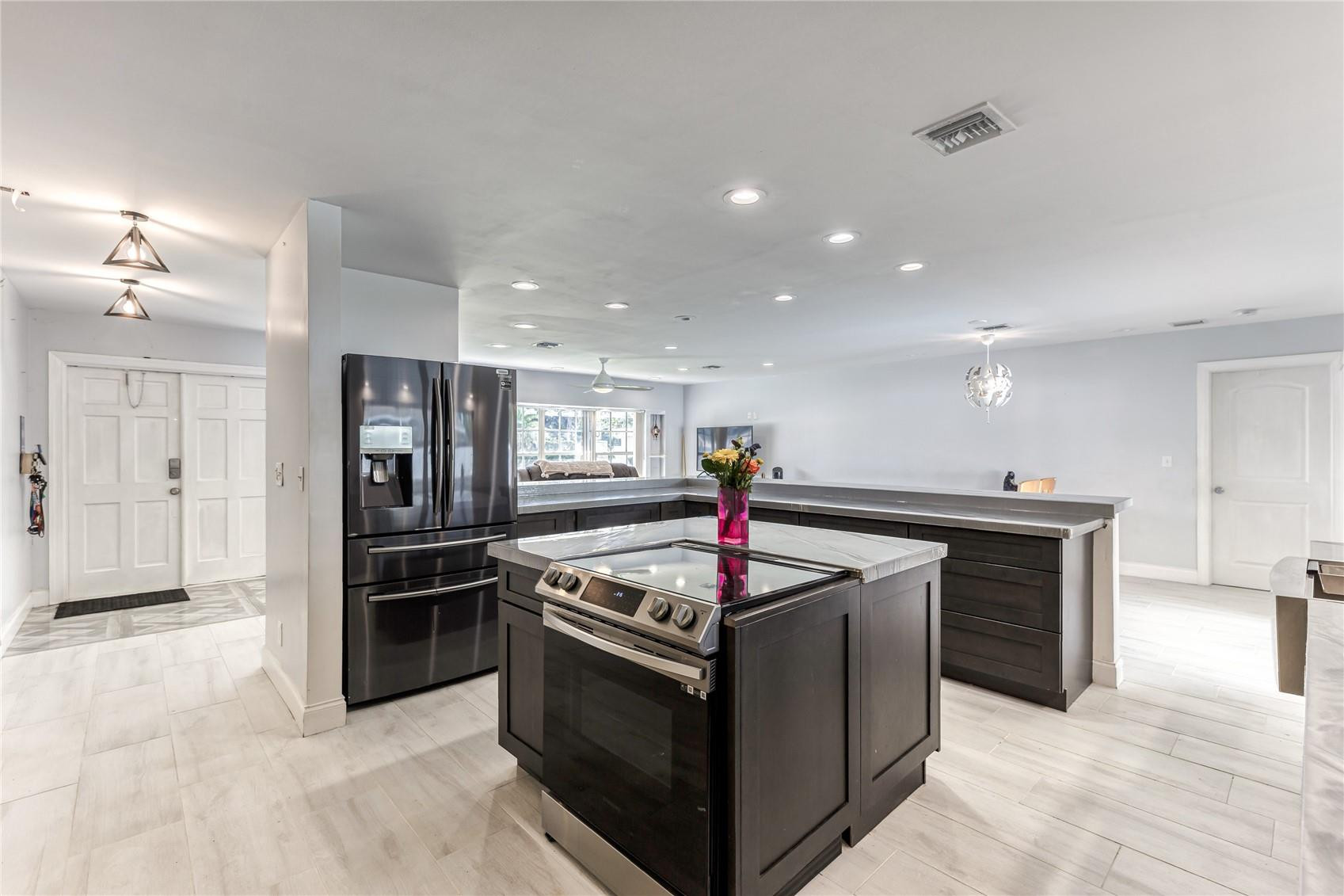 601 Southwest 8th Terrace Boca Raton, FL 33486 - Photo 9 of 47 a kitchen with stainless steel appliances granite countertop a stove and a refrigerator