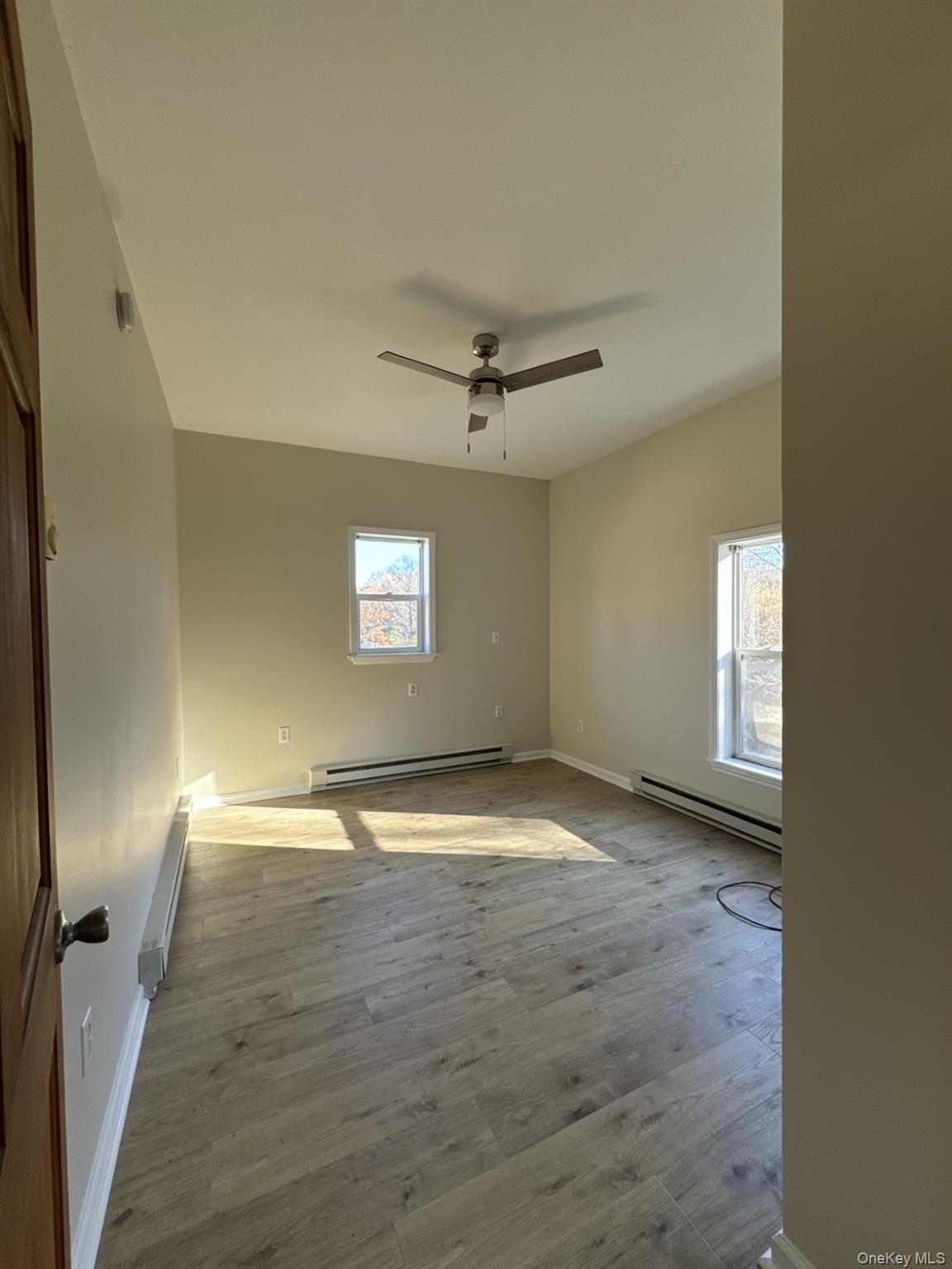 400 Round Lake Road, Unit A Rhinebeck, NY 12572 - Photo 6 of 11 a view of empty room with wooden floor and fan