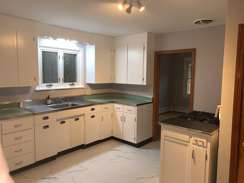 124 Brimfield Road Monson, MA 01057 - Photo 14 of 36 a kitchen with granite countertop white cabinets and sink