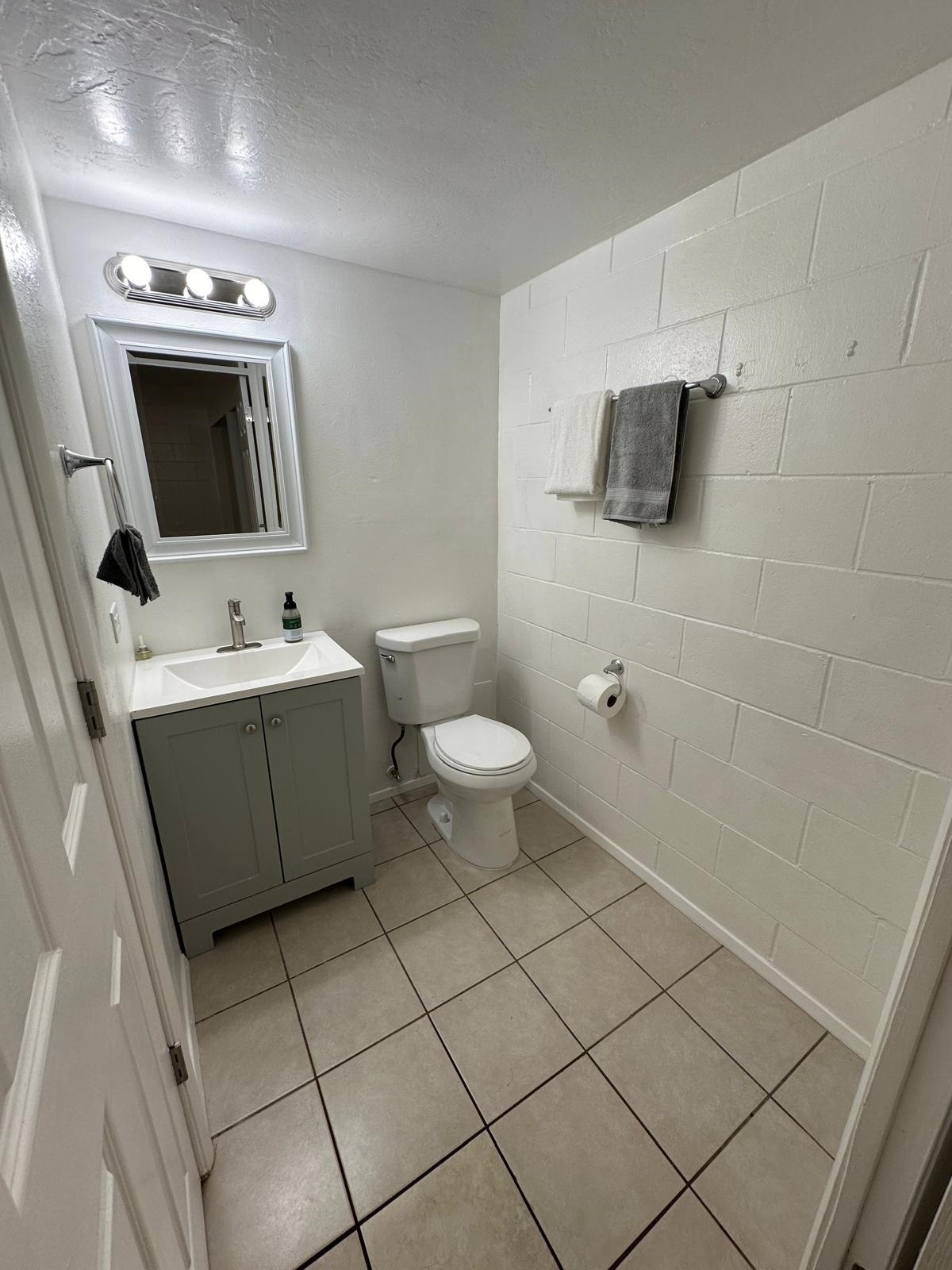 111 Kahului Beach Road, Unit C116 Kahului, HI 96732 - Photo 8 of 14 a bathroom with a toilet sink and mirror