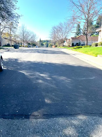 a view of road with large trees