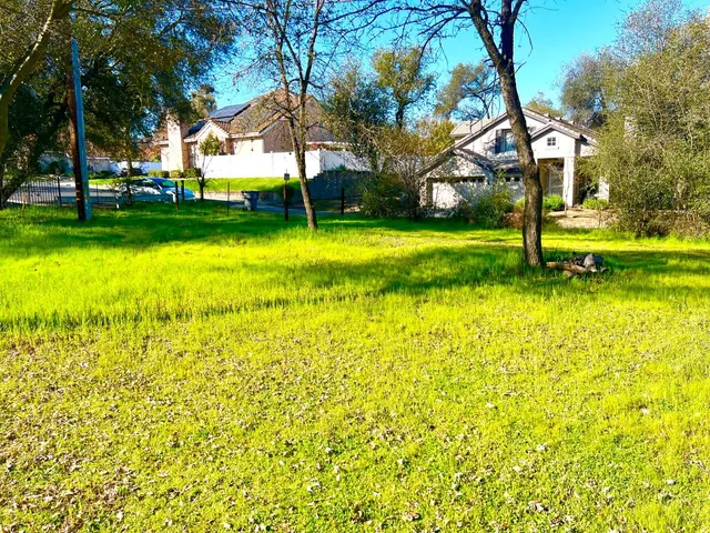 a view of yard with swimming pool and green space