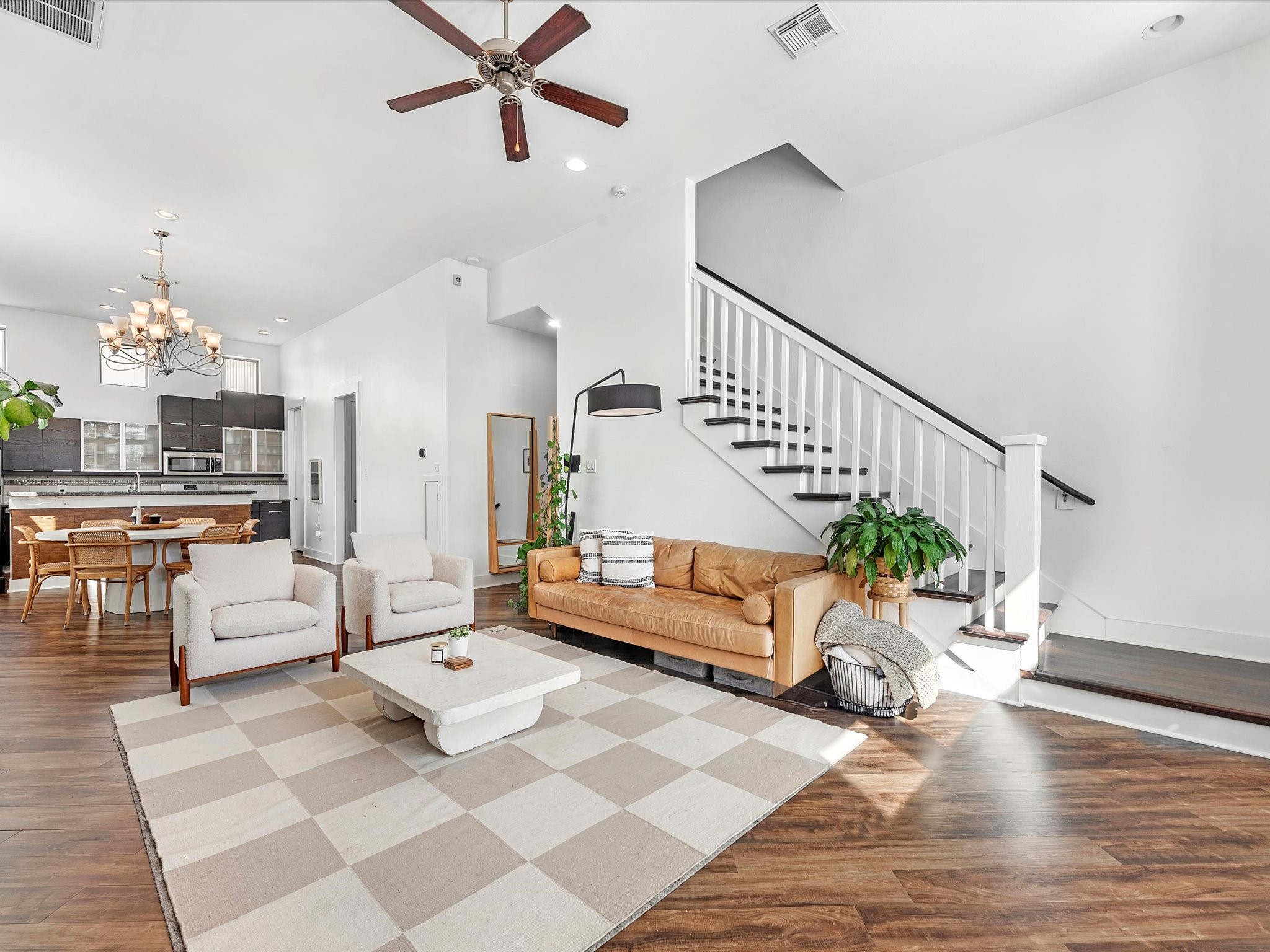 a living room with furniture and wooden floor