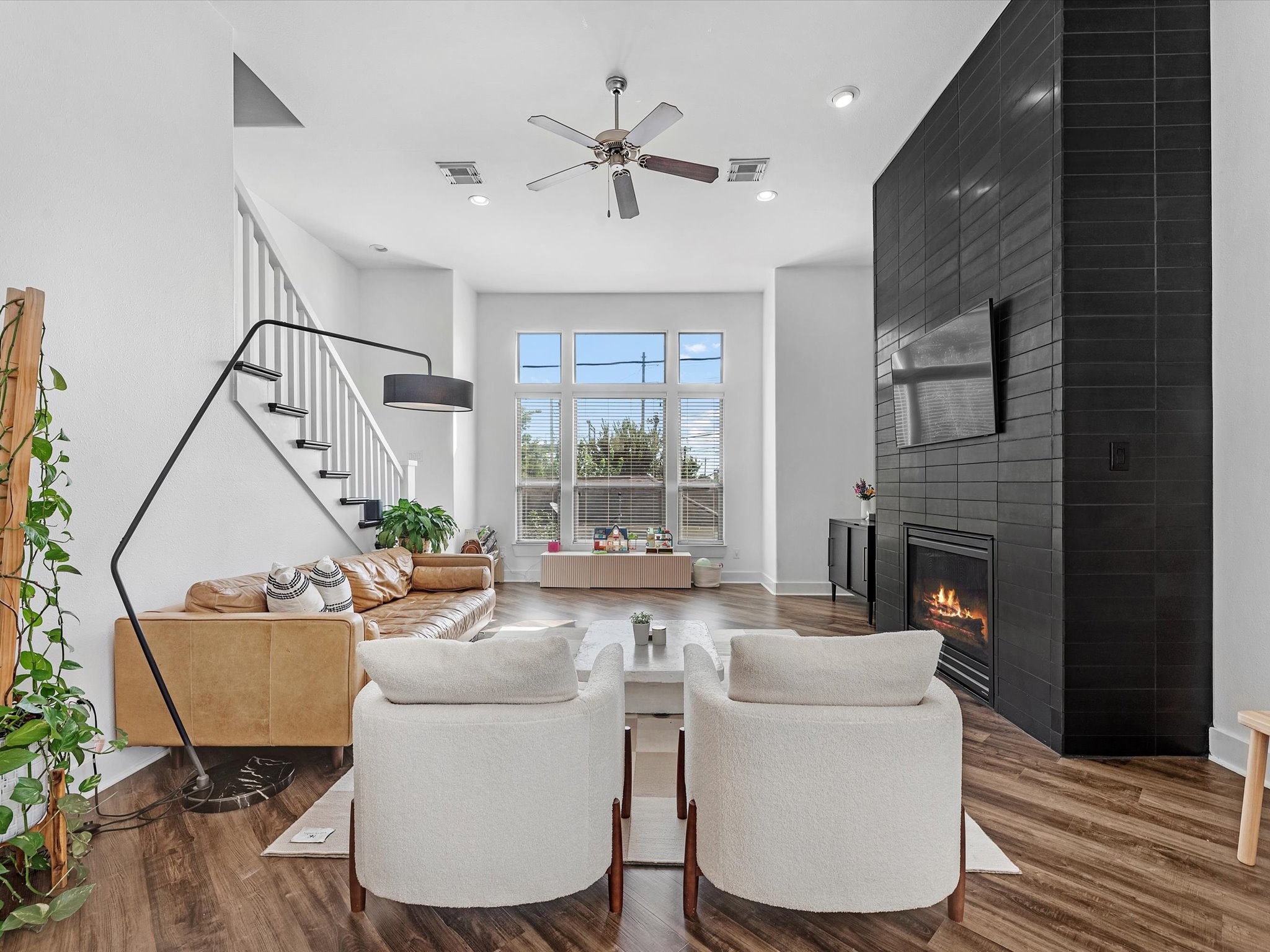 3421 Gillespie Street Houston, TX 77020 - Photo 11 of 34 a living room with furniture a fireplace and a floor to ceiling window