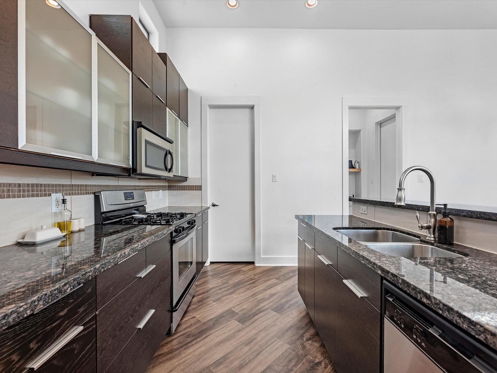 3421 Gillespie Street Houston, TX 77020 - Photo 18 of 34 a kitchen with stainless steel appliances granite countertop a sink stove and cabinets