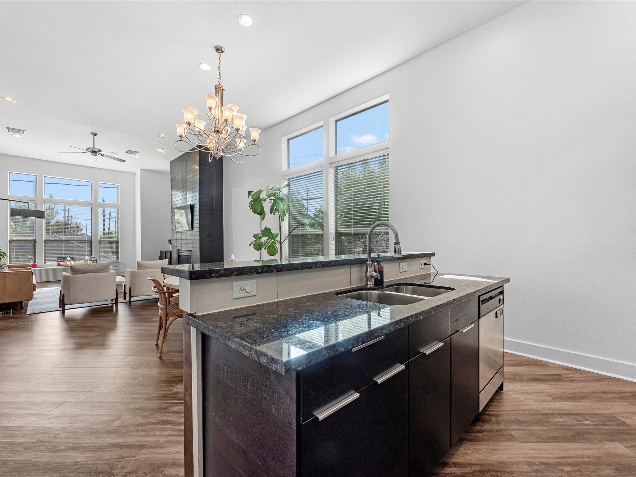 3421 Gillespie Street Houston, TX 77020 - Photo 20 of 34 a dining hall with granite countertop a sink dishwasher and a fireplace with wooden floor