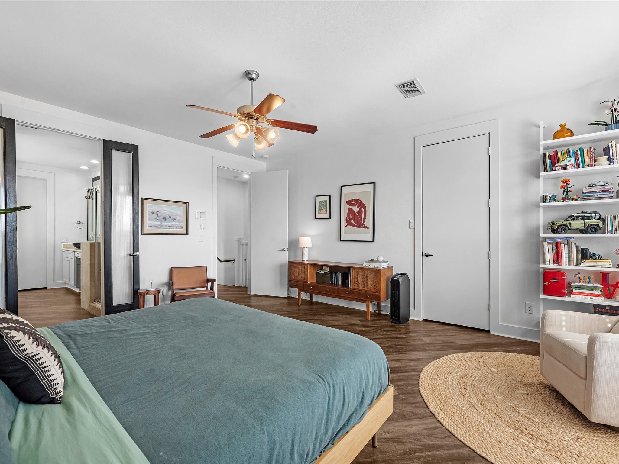 3421 Gillespie Street Houston, TX 77020 - Photo 23 of 34 a bedroom with a bed a dresser and book shelf