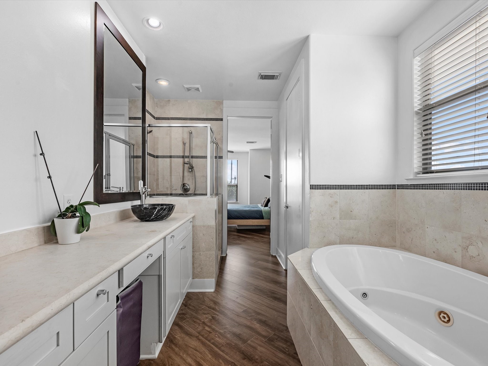 3421 Gillespie Street Houston, TX 77020 - Photo 26 of 34 a bathroom with a double vanity sink a mirror and a bathtub