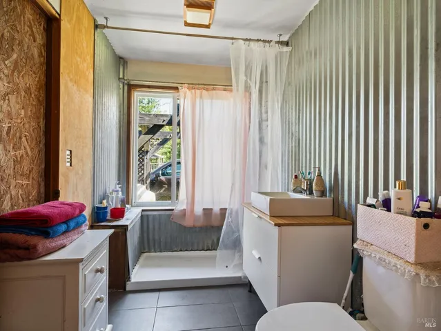 a living room with a couch and a dining table next to a window