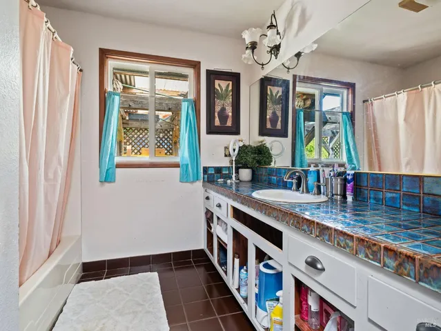 a kitchen with stainless steel appliances granite countertop a sink a stove a window and a dining table