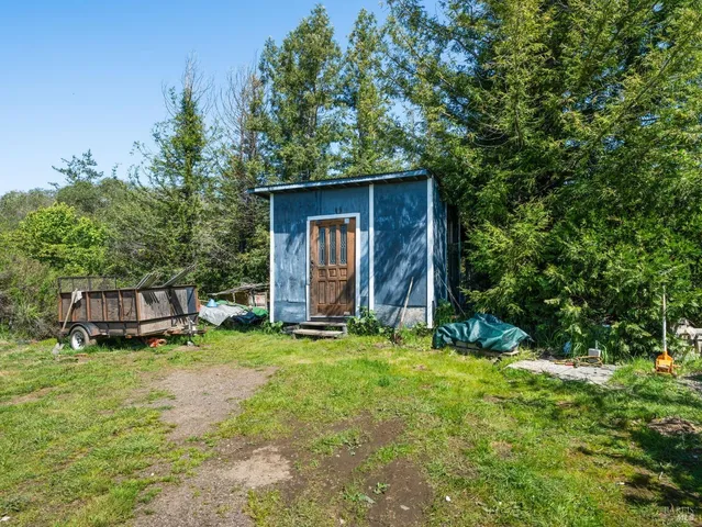 a view of a house with backyard and sitting area