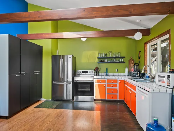 a kitchen with stainless steel appliances granite countertop a refrigerator and a sink