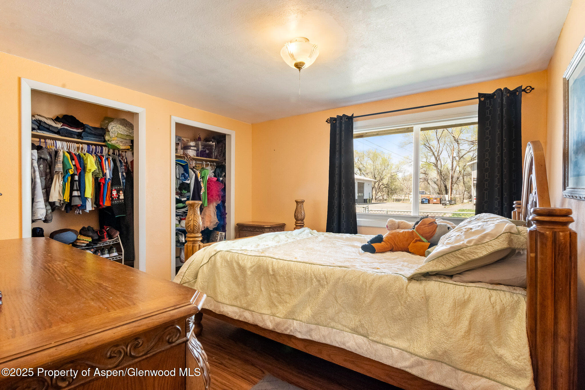 125 East 9th Street Rifle, CO 81650 - Photo 16 of 29 a bed sitting in a bedroom next to a window