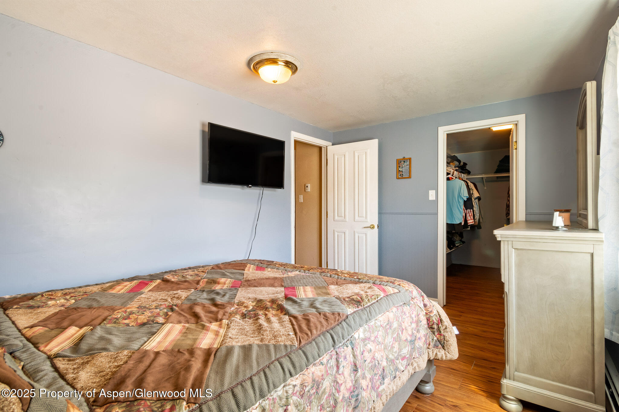 125 East 9th Street Rifle, CO 81650 - Photo 18 of 29 a bedroom with a bed and a flat screen tv
