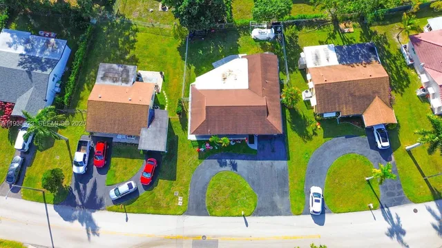 an aerial view of multiple house with outdoor space and swimming pool