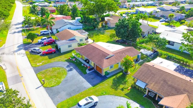 an aerial view of a swimming pool patio chairs and fire pit