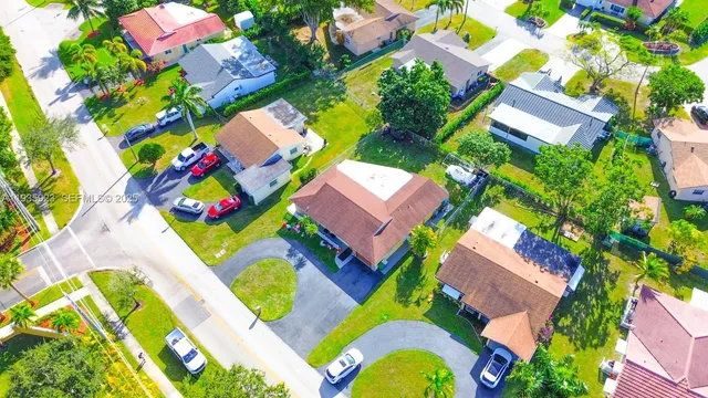 an aerial view of a house with a swimming pool outdoor seating