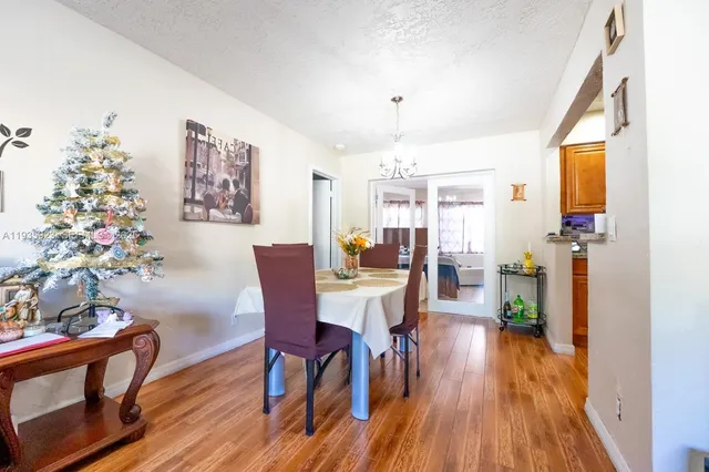 a view of a dining room with furniture wooden floor and a chandelier