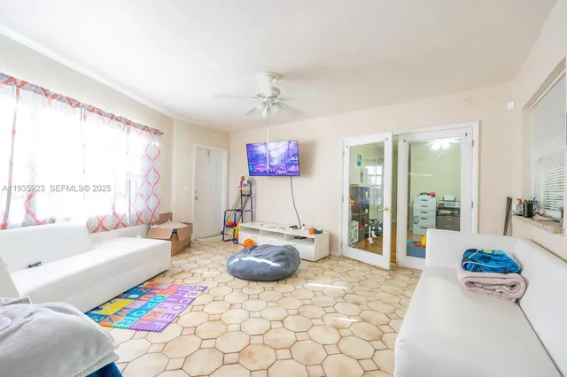 a bedroom with furniture and a large window