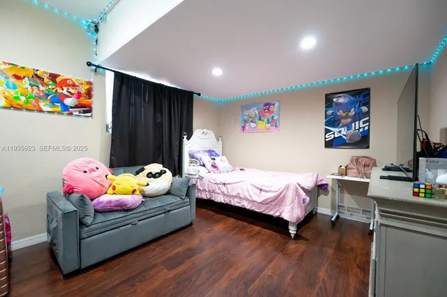 a bedroom with furniture and wooden floor