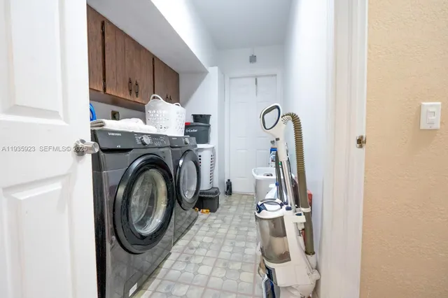 a view of a storage and utility room with washer and dryer