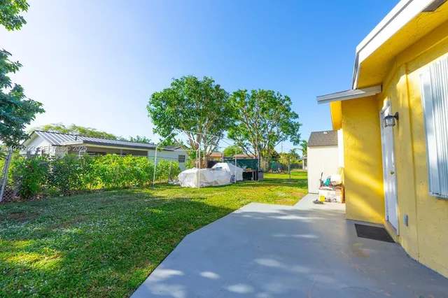 a view of a swimming pool with a yard