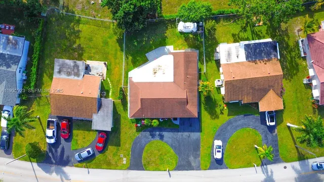an aerial view of residential house with outdoor space and swimming pool