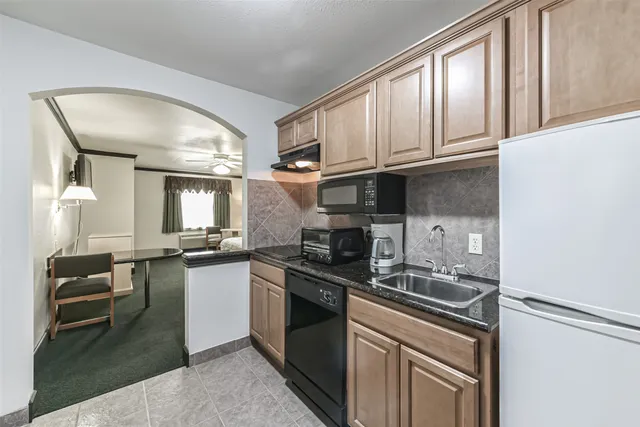 a kitchen with granite countertop stainless steel appliances and wooden cabinets