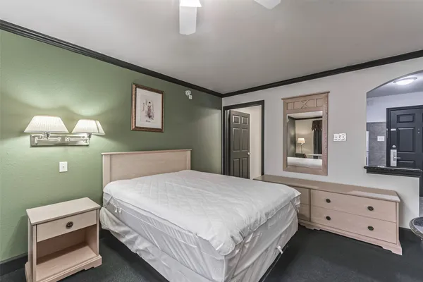 a bedroom with a bed and a night stand