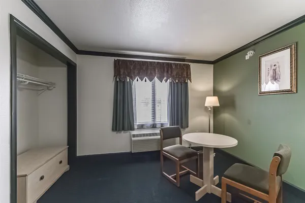 a view of a room with a table and chairs