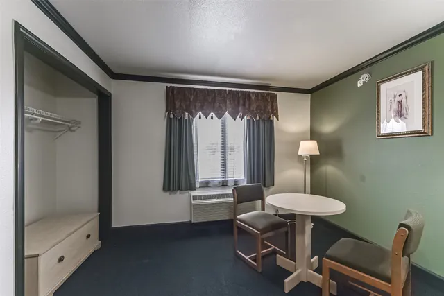 a view of a room with a table and chairs