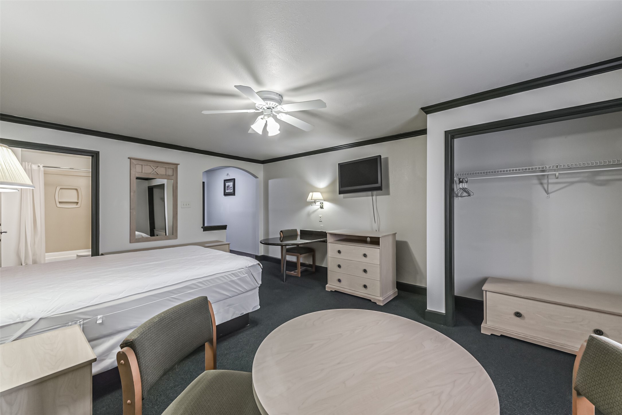 1025 Swanson Street, Unit 311 Houston, TX 77030 - Photo 18 of 26 a spacious bedroom with a bed and a chandelier