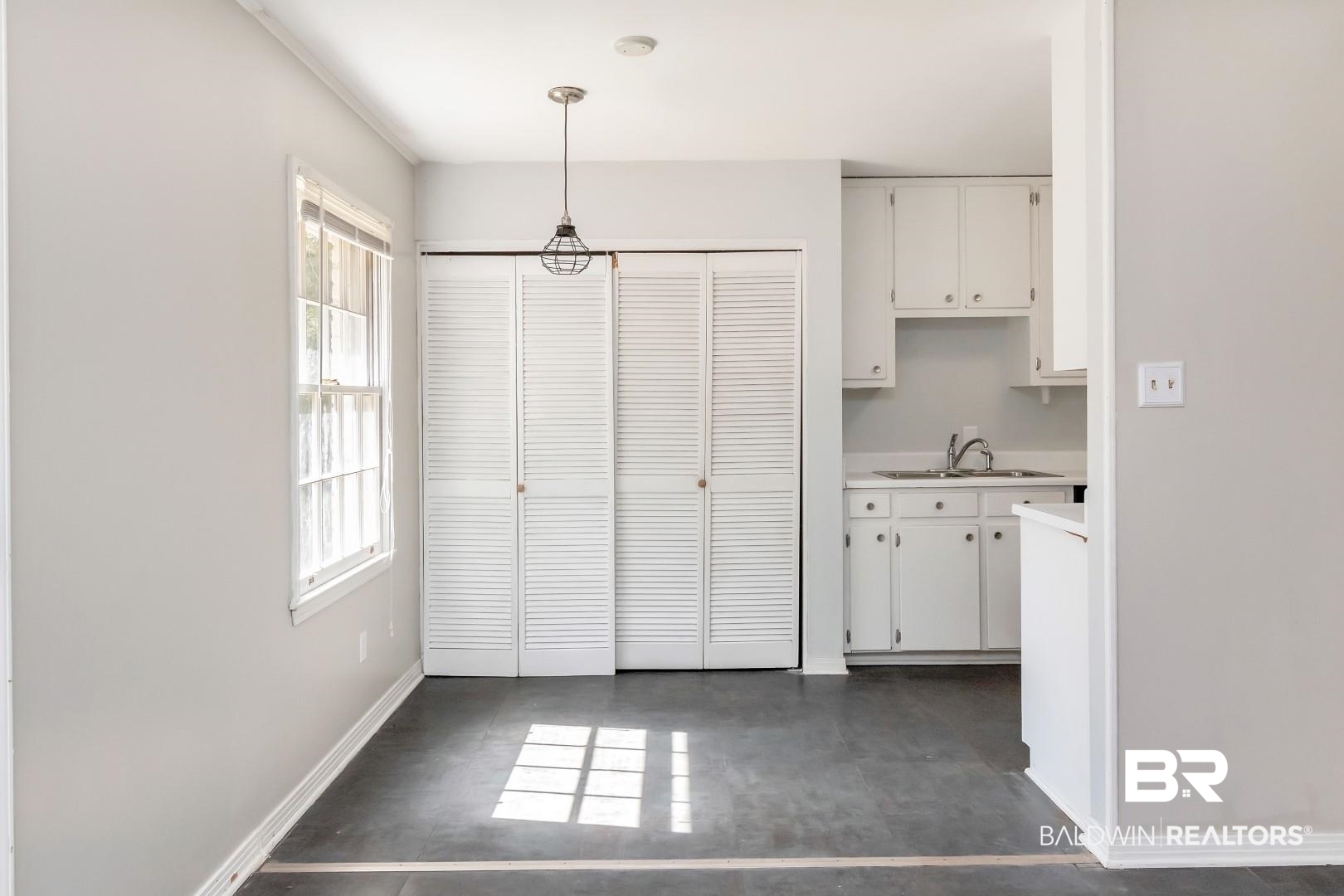 320 Vanderbilt Drive Mobile, AL 36608 - Photo 16 of 39 Kitchen featuring white cabinetry, hanging light fixtures, and sink