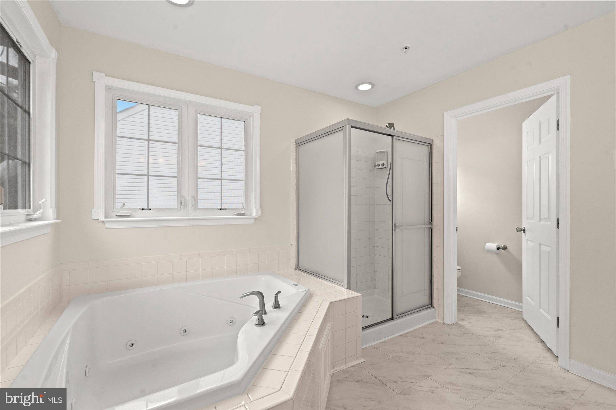 9618 Stuart Lane Clinton, MD 20735 - Photo 16 of 38 Primary Bathroom with Shower and Soaking Tub