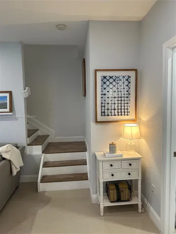 a view of entryway and hall with a chair