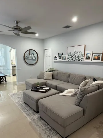 a living room with furniture and wall paintings