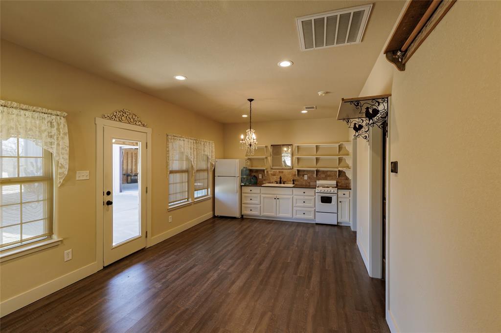 1433 County Road 1180 Decatur, TX 76234 - Photo 29 of 36 a view of a kitchen with refrigerator and wooden floor