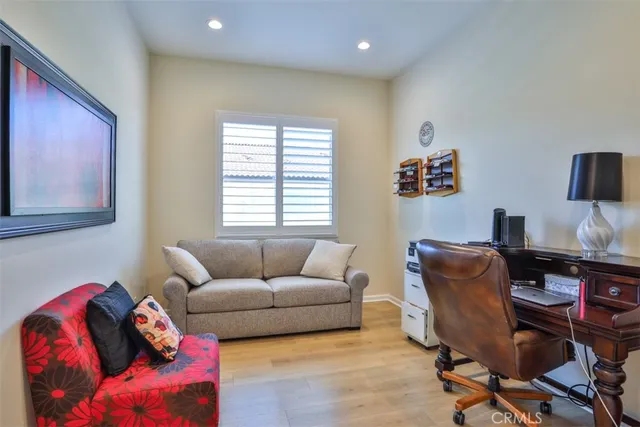a view of a workspace with furniture and wooden floor