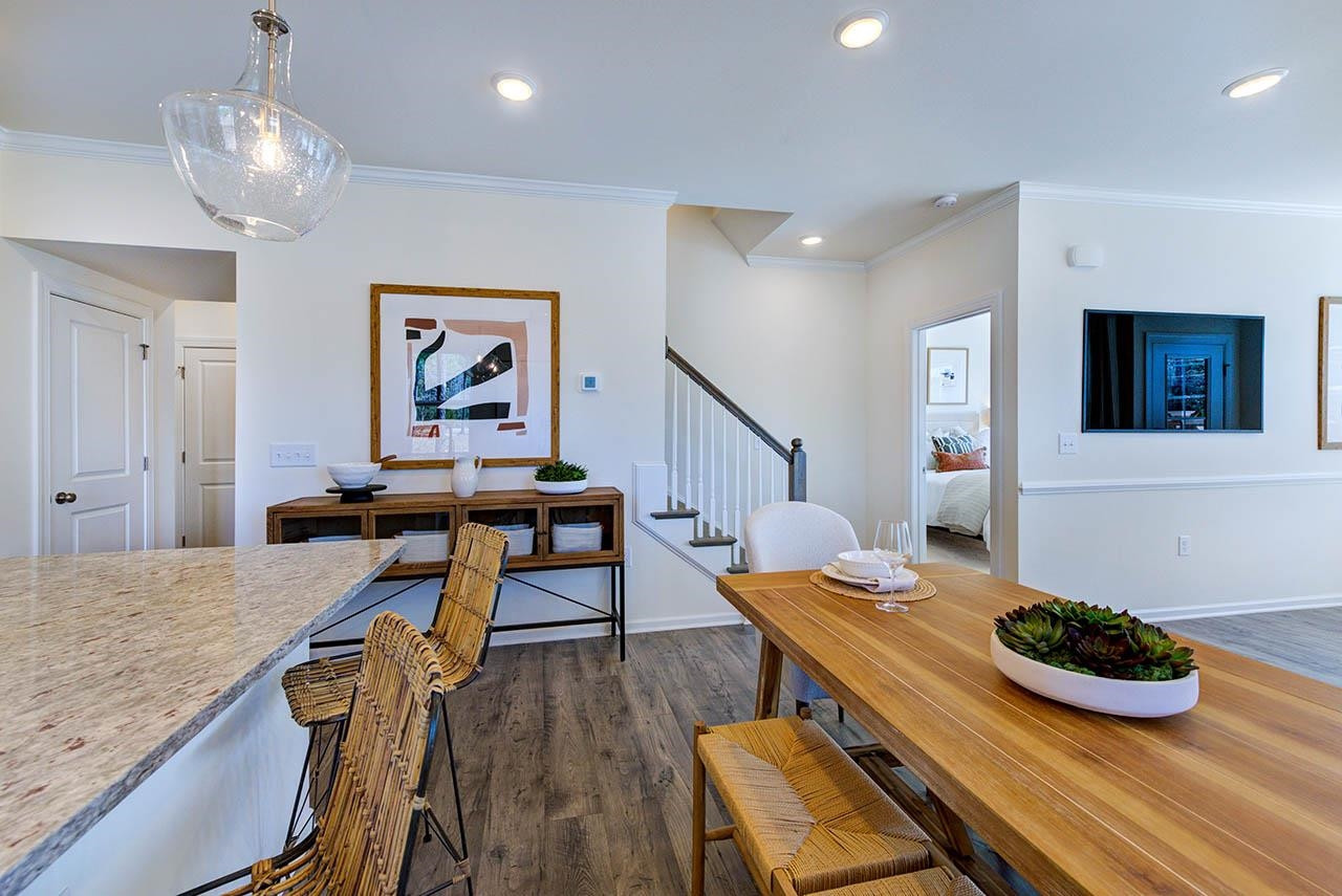 1714 Wimberly Road Apex, NC 27523 - Photo 17 of 45 a view of a dining room with furniture and wooden floor