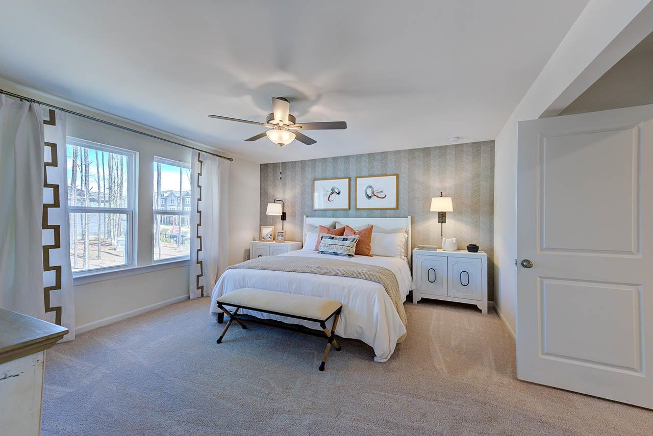 1714 Wimberly Road Apex, NC 27523 - Photo 22 of 45 a bed room with a bed and a chandelier