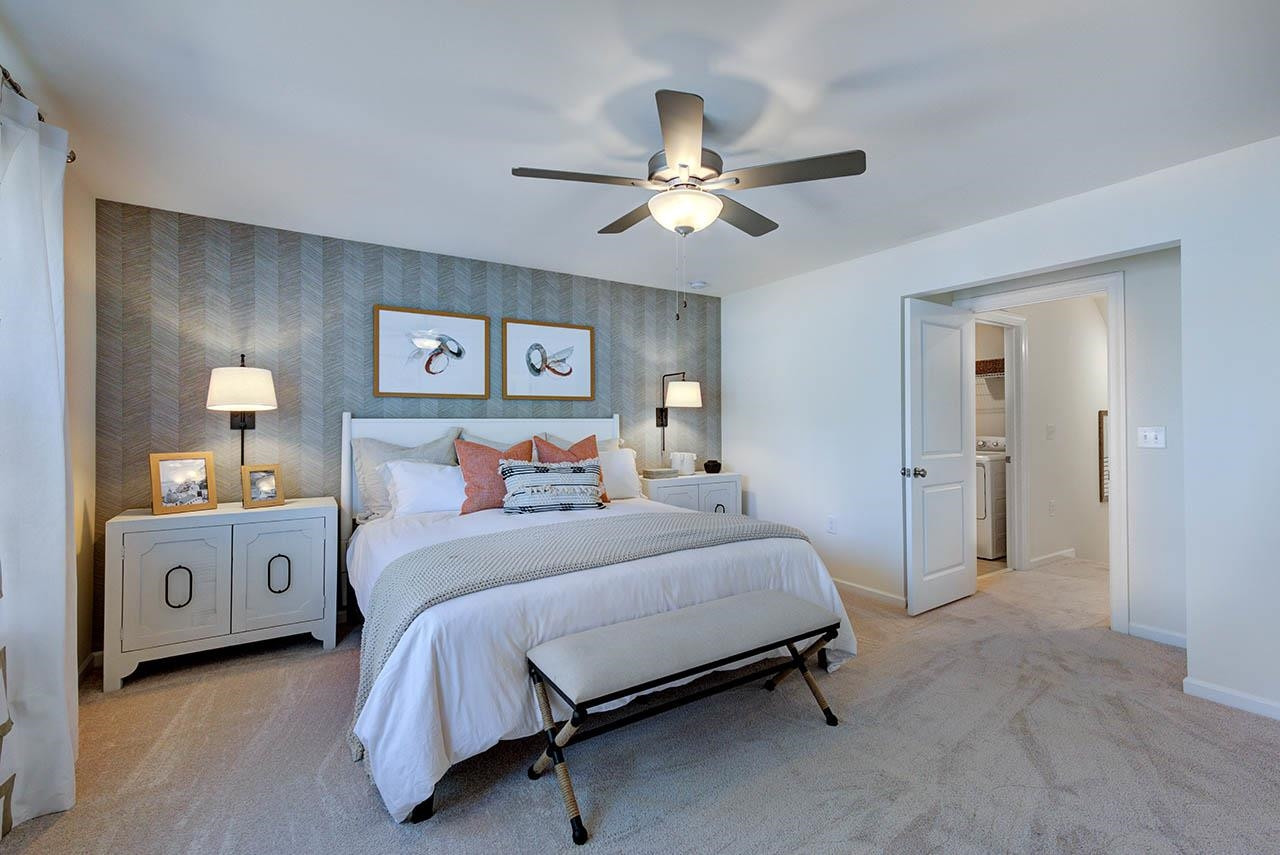 1714 Wimberly Road Apex, NC 27523 - Photo 23 of 45 a bedroom with a bed and a chandelier